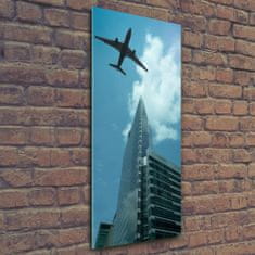 Wallmuralia Vertikální Fotoobraz na skle Letadlo nad městem 50x125 cm 4 úchytky